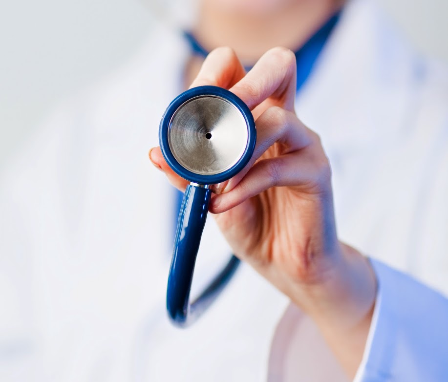 A doctor holding on the end of a stethoscope