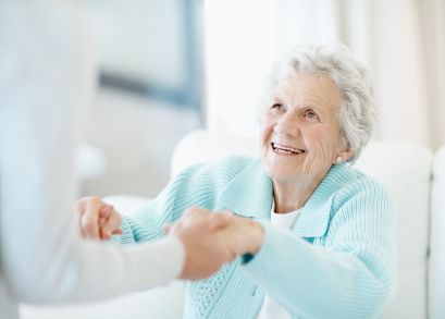 A person holding hands with an elderly woman representing the personal care for seniors at MasterPeace Home Health Care in Mattapoisett, MA